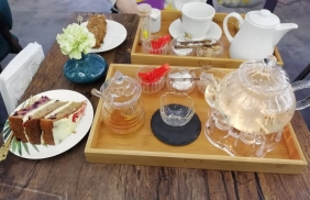 Trays of tea and pieces of cake